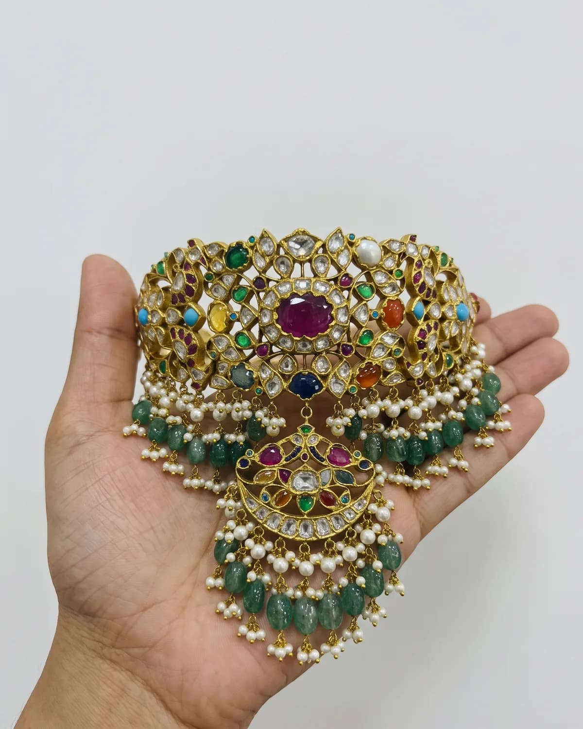 Bejai Navratan Choker Necklace in 18K gold — In the hand, for scale